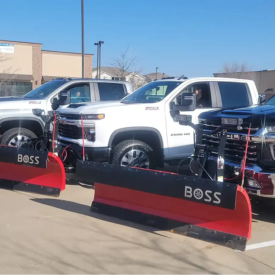 Shutt Lawn Care professionals, small fleet of four-door trucks with BOSS snow plow attachments, prepped for commercial snow removal - Springfield, IL